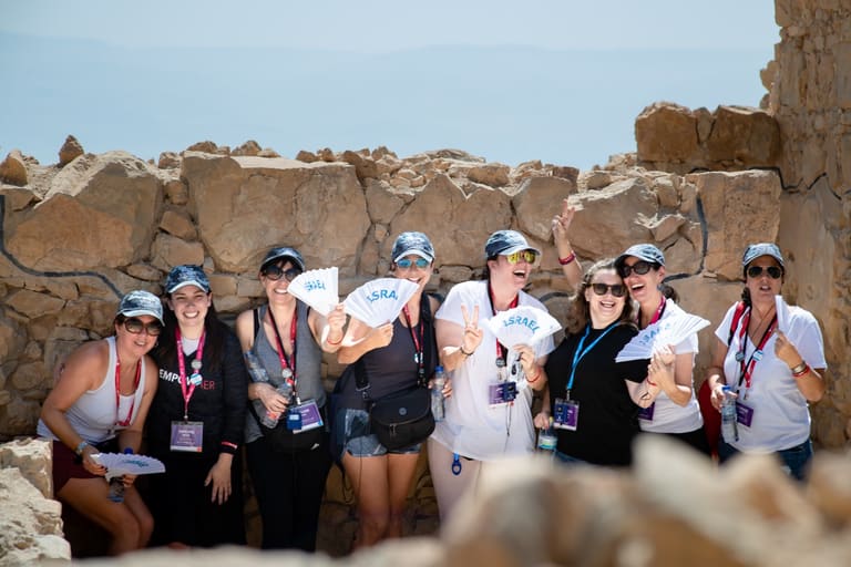 The group celebrating with Israel fans among the ruins at the top of Masada