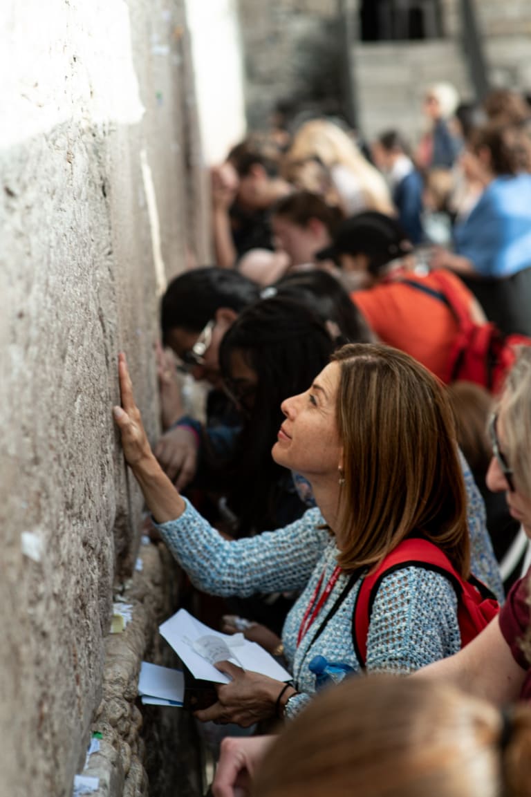 A Jewish mother placing her hand on the Western Wall in Jerusalem